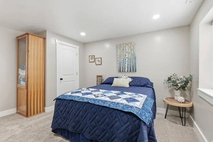 Bedroom featuring light carpet and recessed lighting
