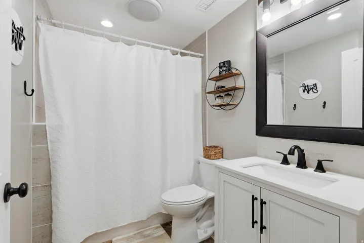 Full bath featuring vanity, a shower with curtain, and recessed lighting
