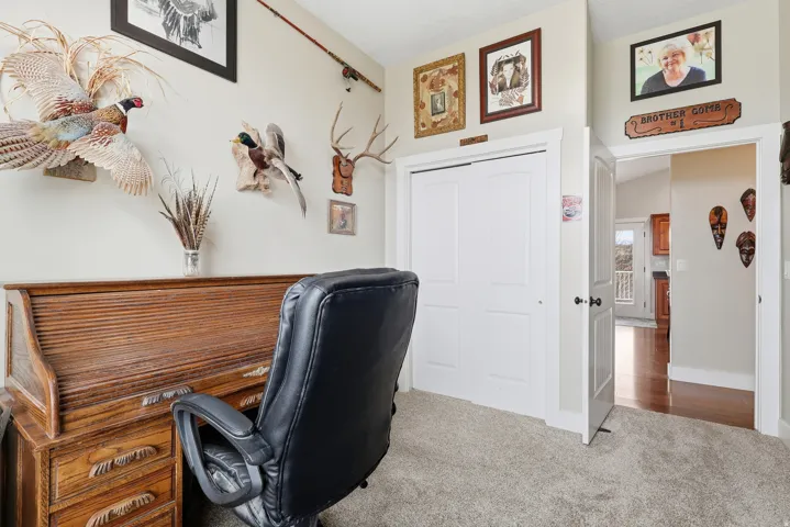 Home office featuring carpet flooring and baseboards