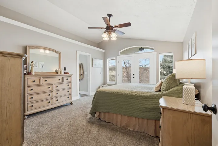 Bedroom with french doors, lofted ceiling, light colored carpet, ceiling fan, and access to outside