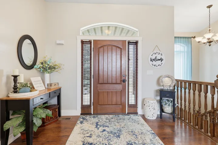 Entrance foyer featuring dark wood-style floors and hanging lights