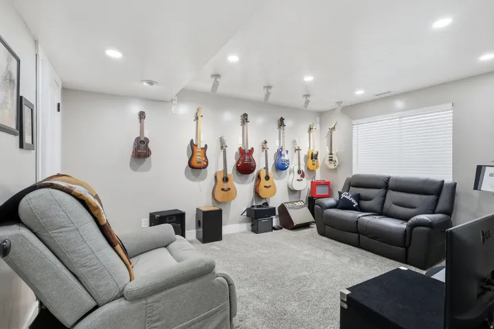 Living area with carpet floors and recessed lighting