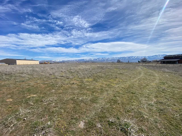 View of yard featuring a view of rural / pastoral area and a mountain view