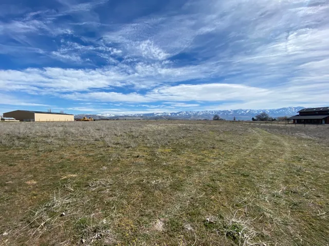 View of yard with a rural view and a mountain view