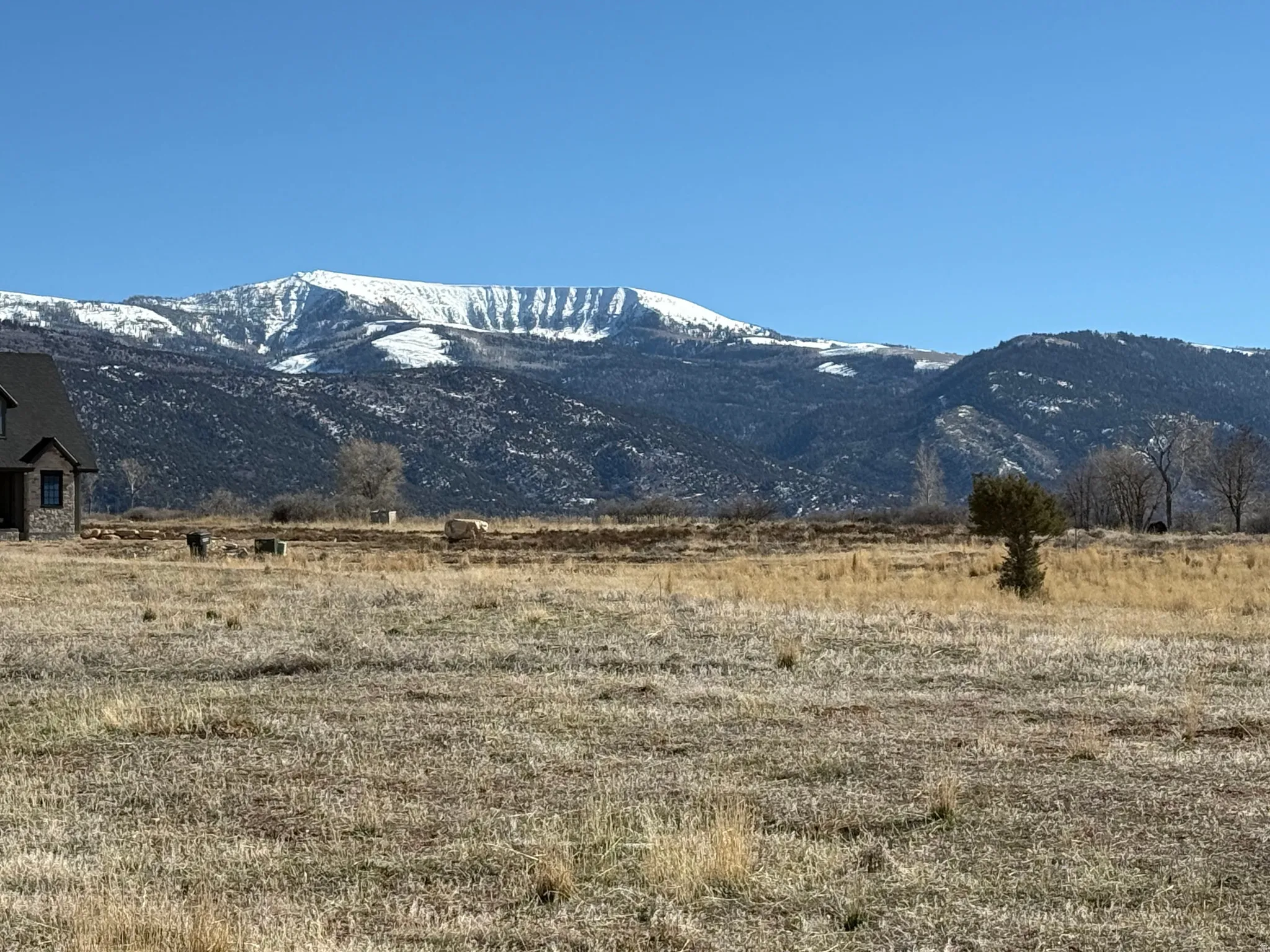 View of mountain backdrop featuring rural landscape