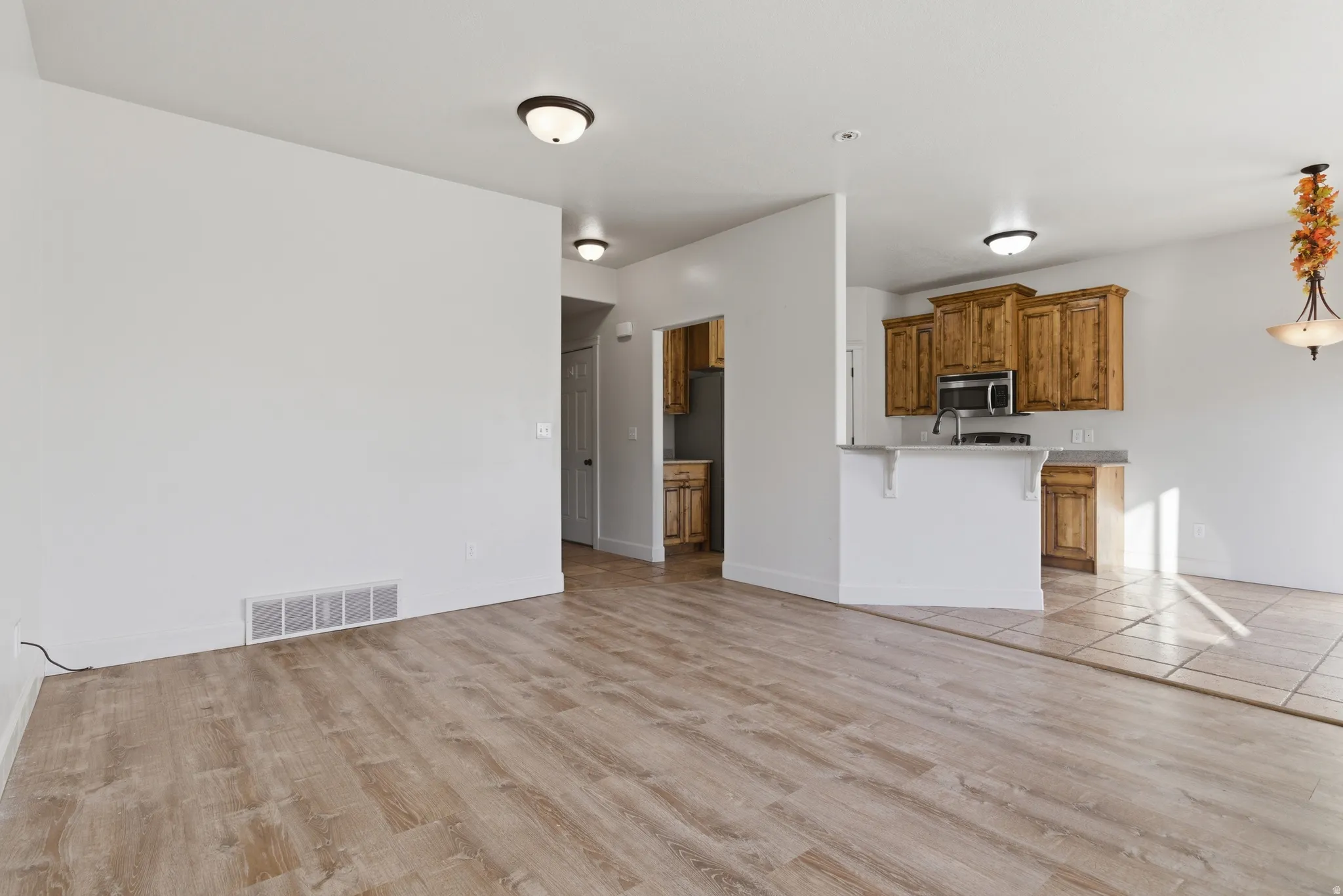 Unfurnished living room featuring light wood-style floors