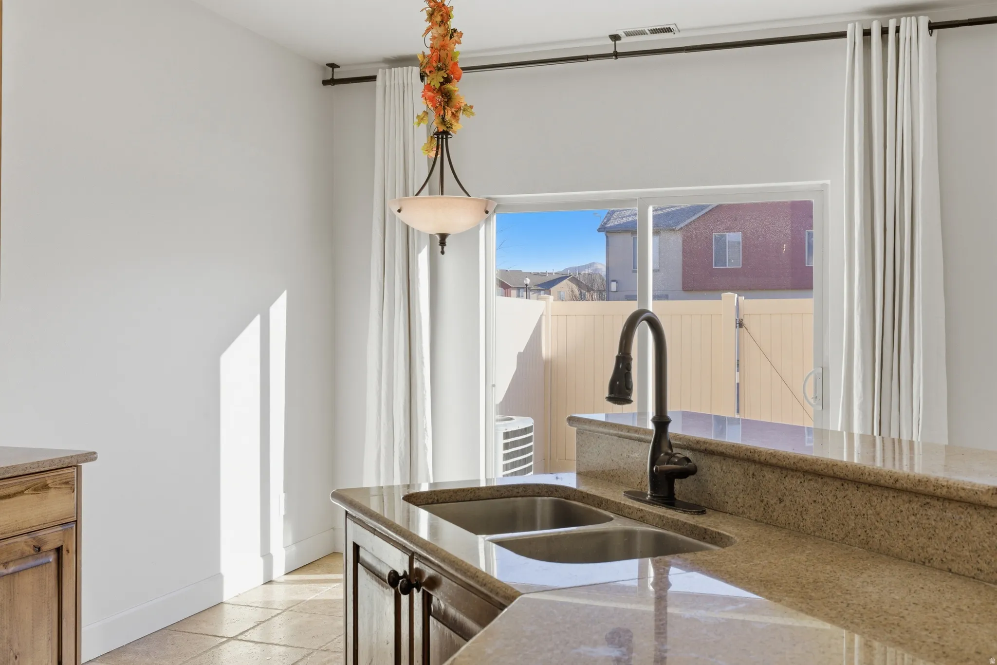 Kitchen featuring light stone countertops and a sink