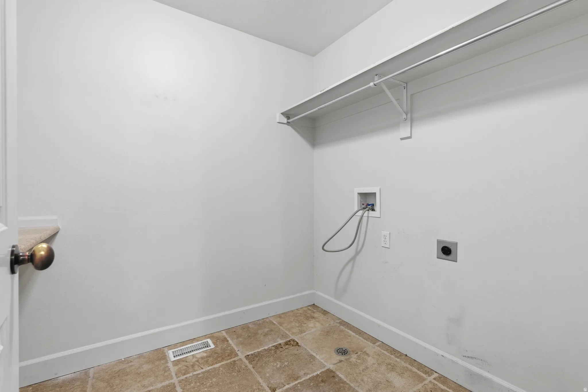 Laundry room with hookup for an electric dryer and hookup for a washing machine