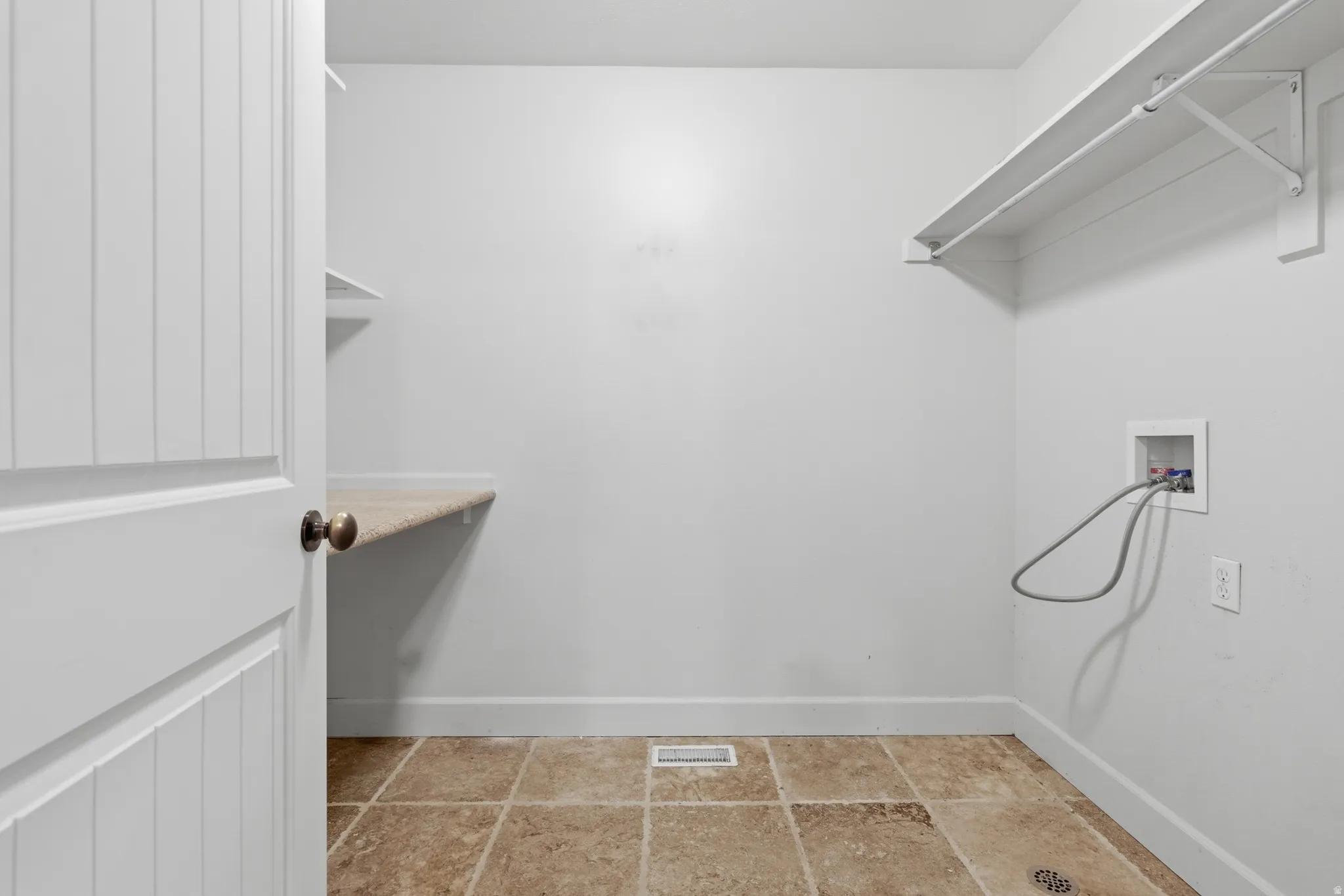 Laundry room with baseboards and hookup for a washing machine