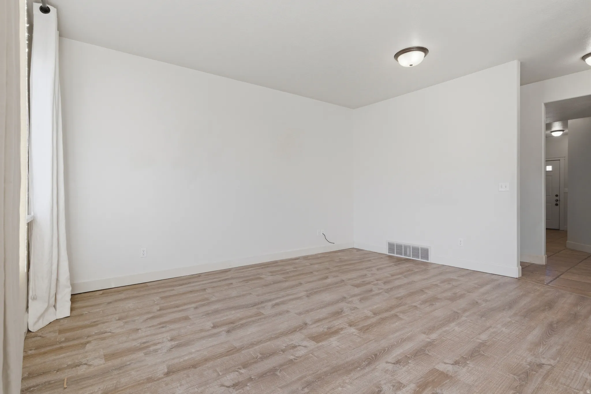 Unfurnished room featuring light wood finished floors