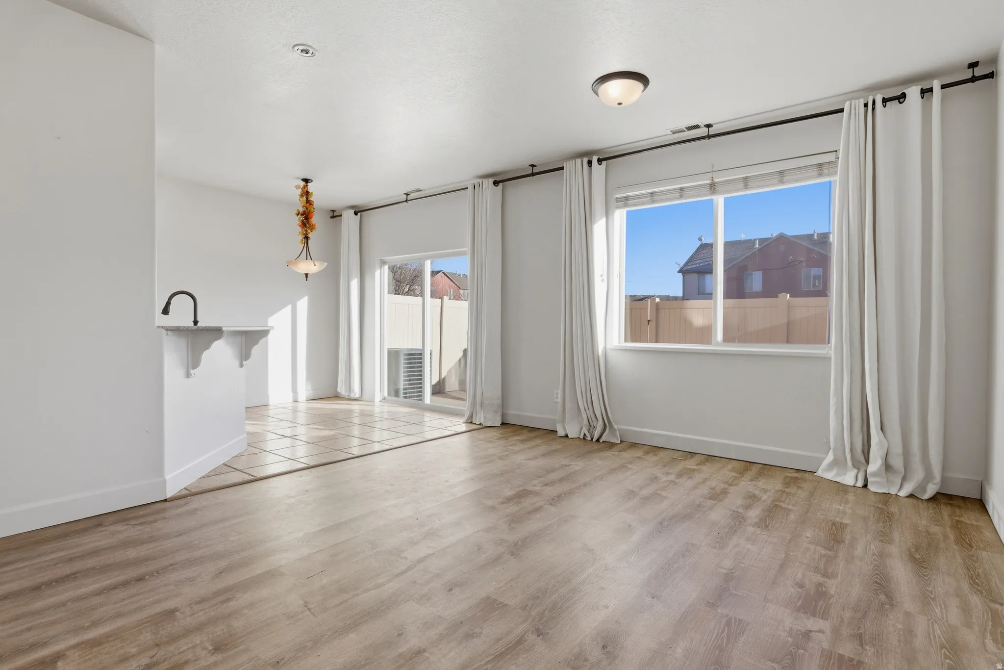Spare room with baseboards and light wood finished floors