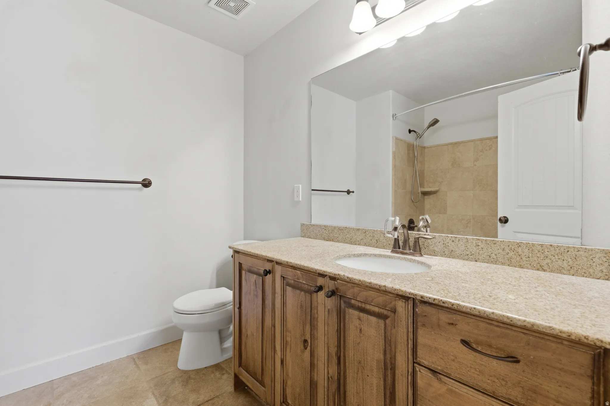 Full bathroom with vanity, a shower, and light tile patterned floors