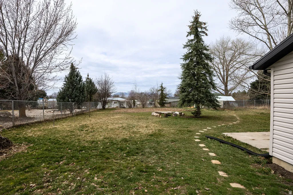 Fenced backyard with a patio