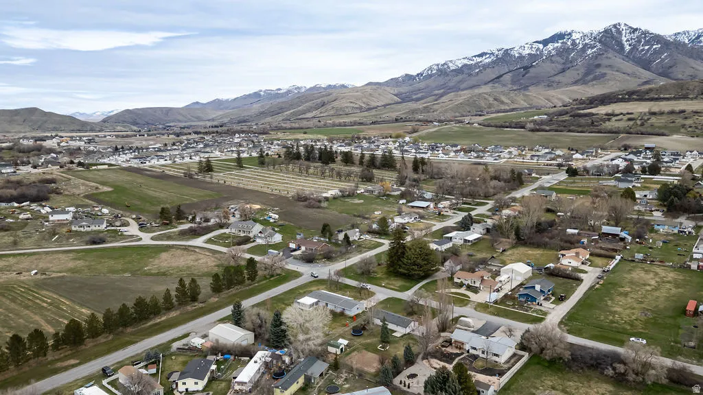 Overview of rural landscape with a mountain backdrop and nearby suburban area