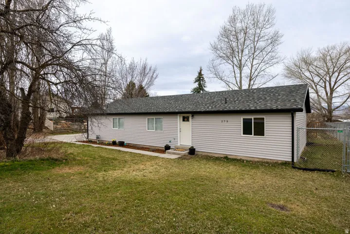 Back of property featuring a shingled roof and entry steps