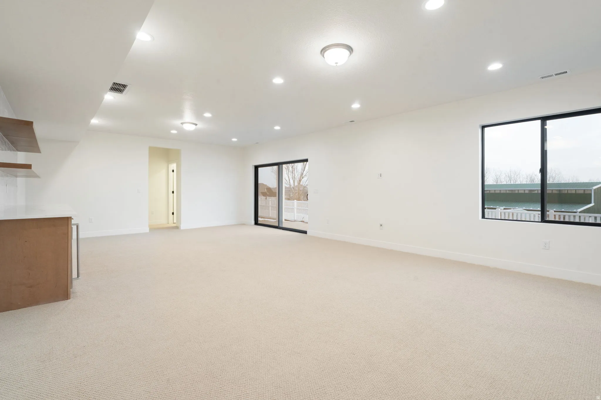 Unfurnished room featuring light colored carpet and recessed lighting