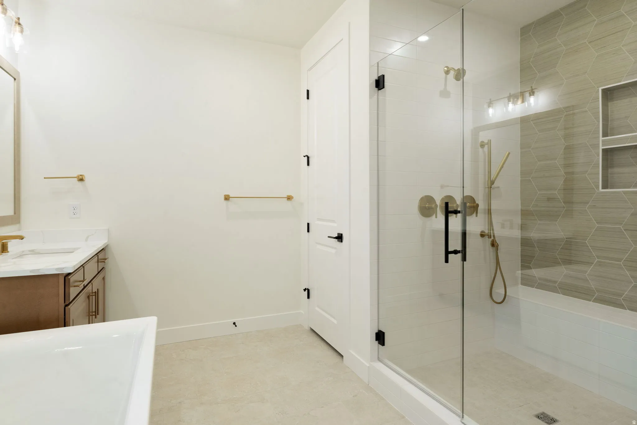 Bathroom with vanity, a stall shower, and a soaking tub