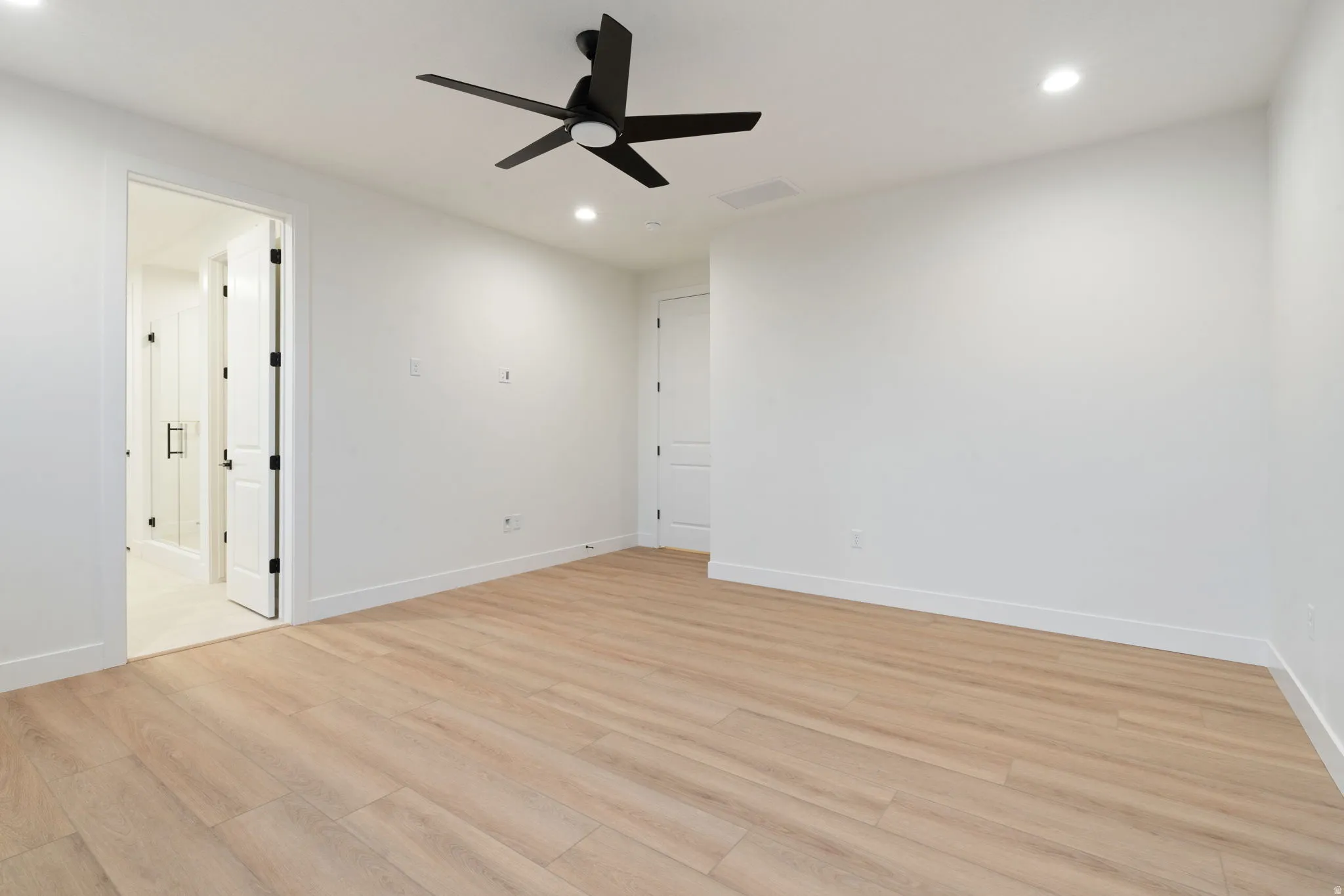 Unfurnished bedroom with light wood finished floors, a ceiling fan, and recessed lighting