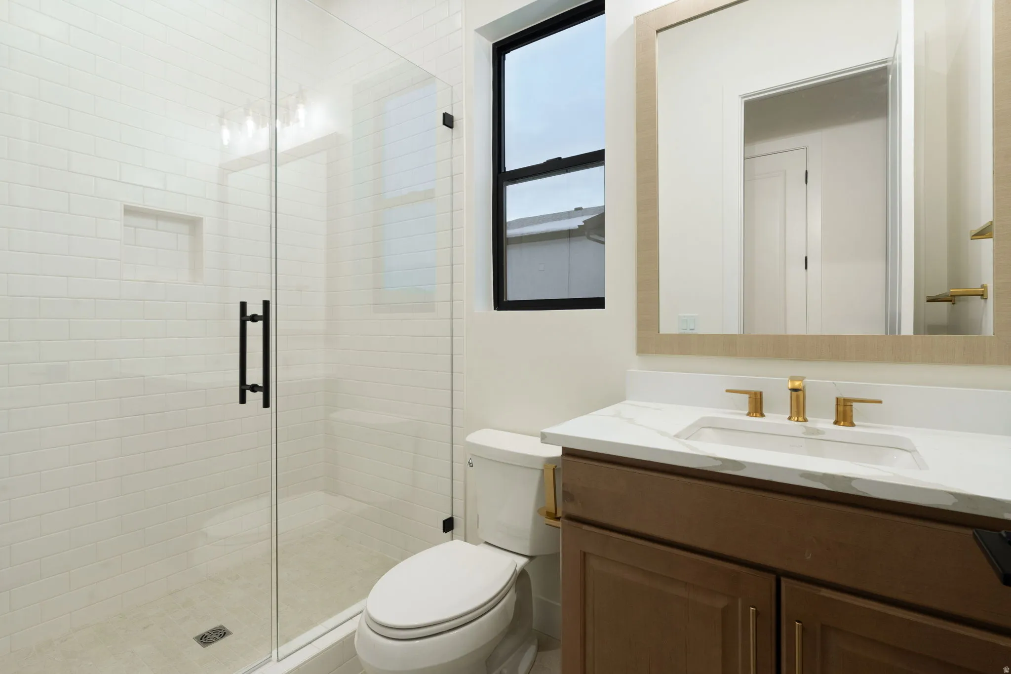 Full bath featuring a stall shower and vanity