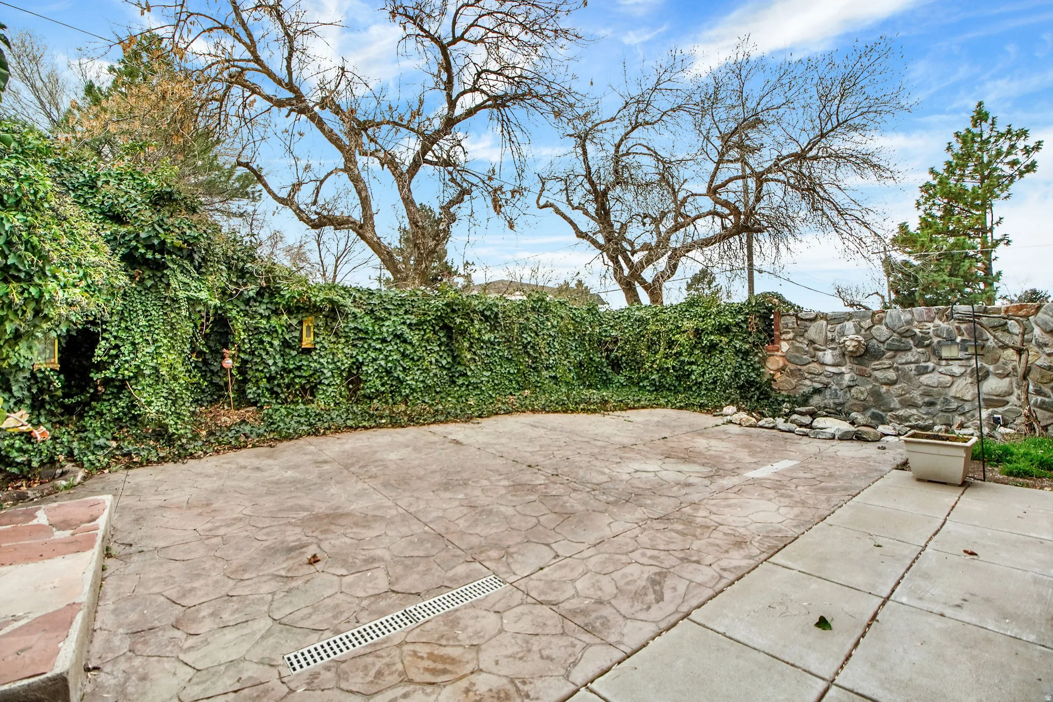 Fenced backyard with a patio area