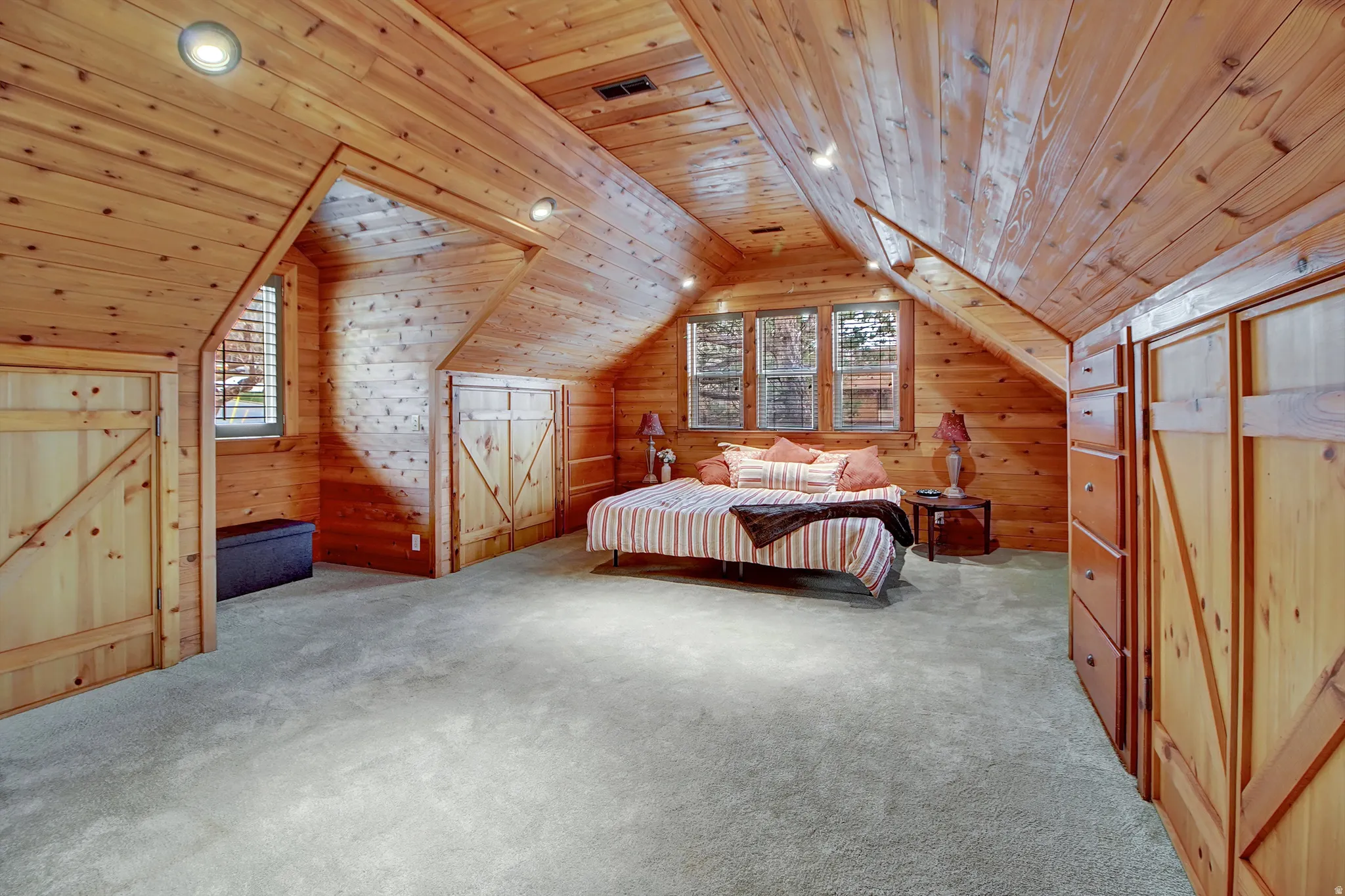 Bedroom with a vaulted wood ceiling, wood walls, recessed lighting, and carpet