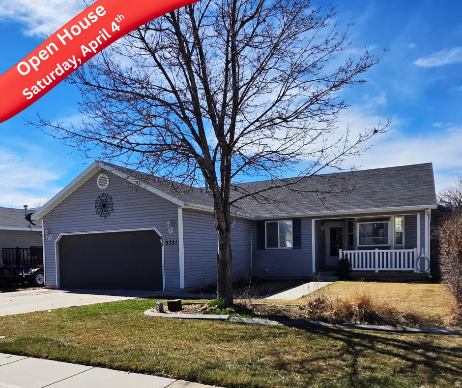 Ranch-style house featuring an attached garage, a front yard, a porch, and driveway