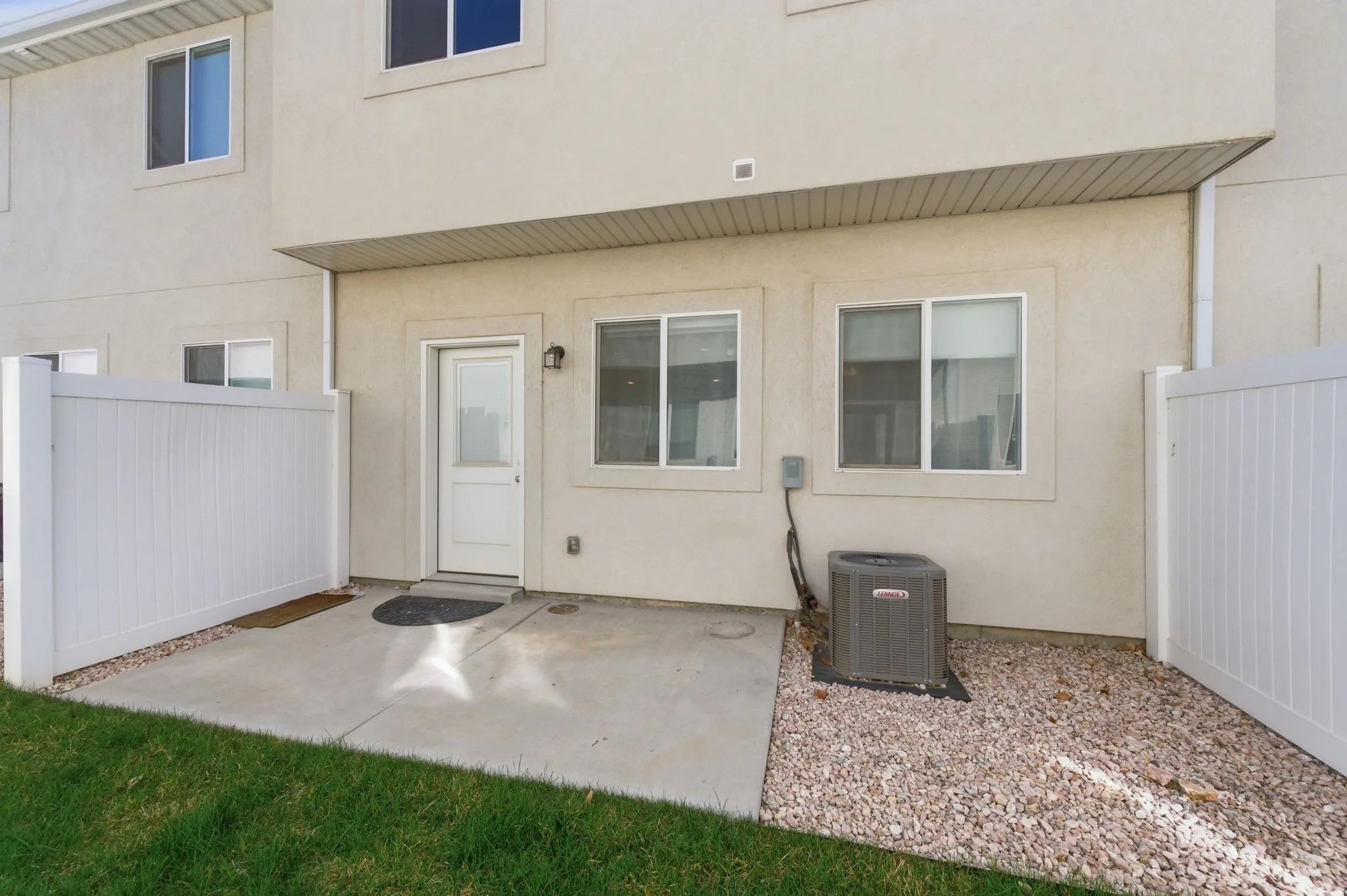 Property entrance with stucco siding and a patio