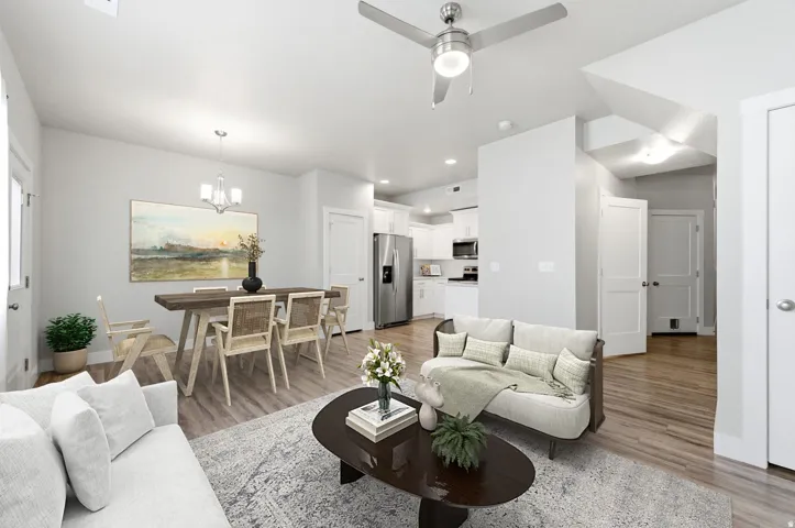 Open-concept living space featuring wood-finish flooring, recessed lighting, and a neutral wall palette