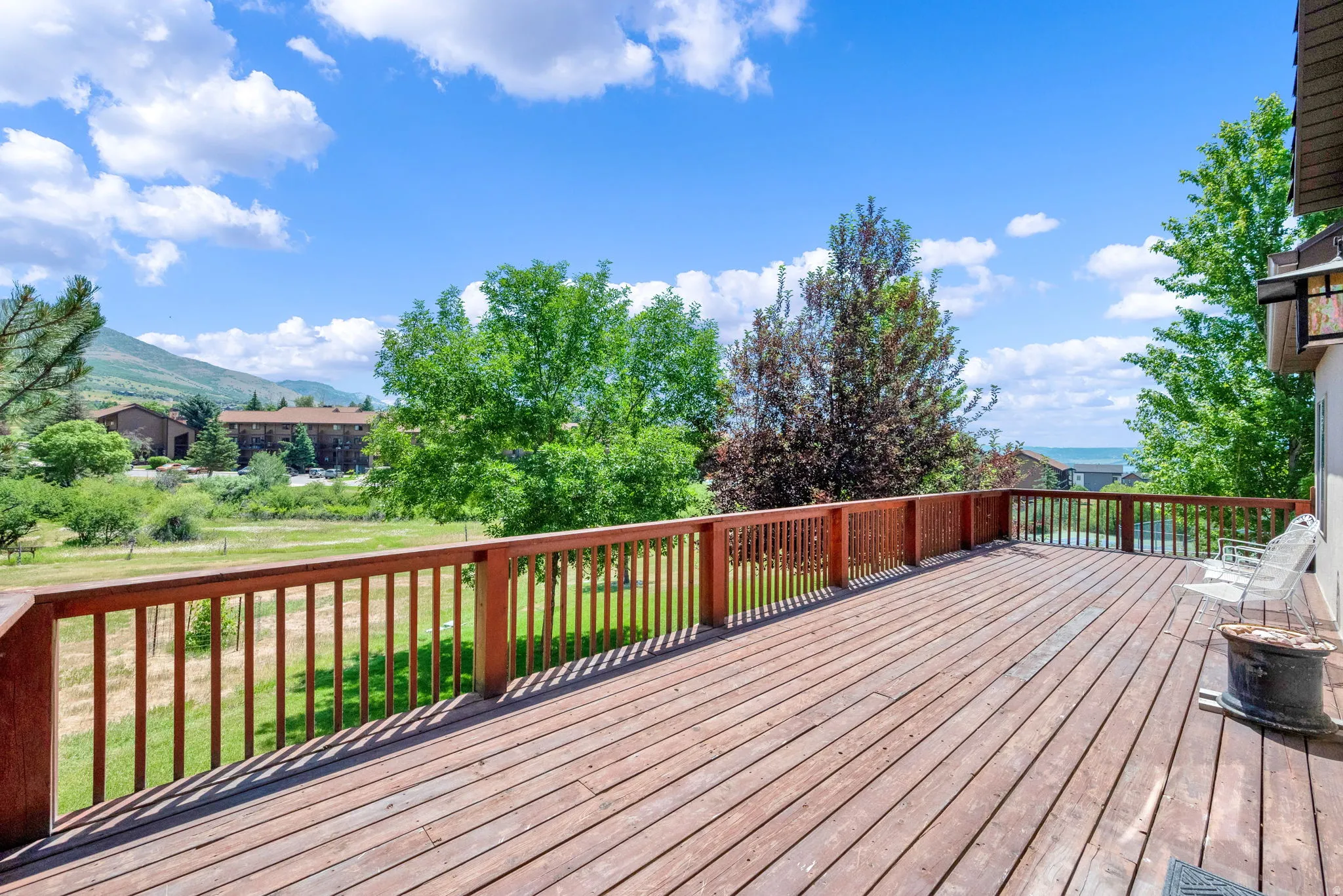 Wooden deck with a lawn and a mountain view