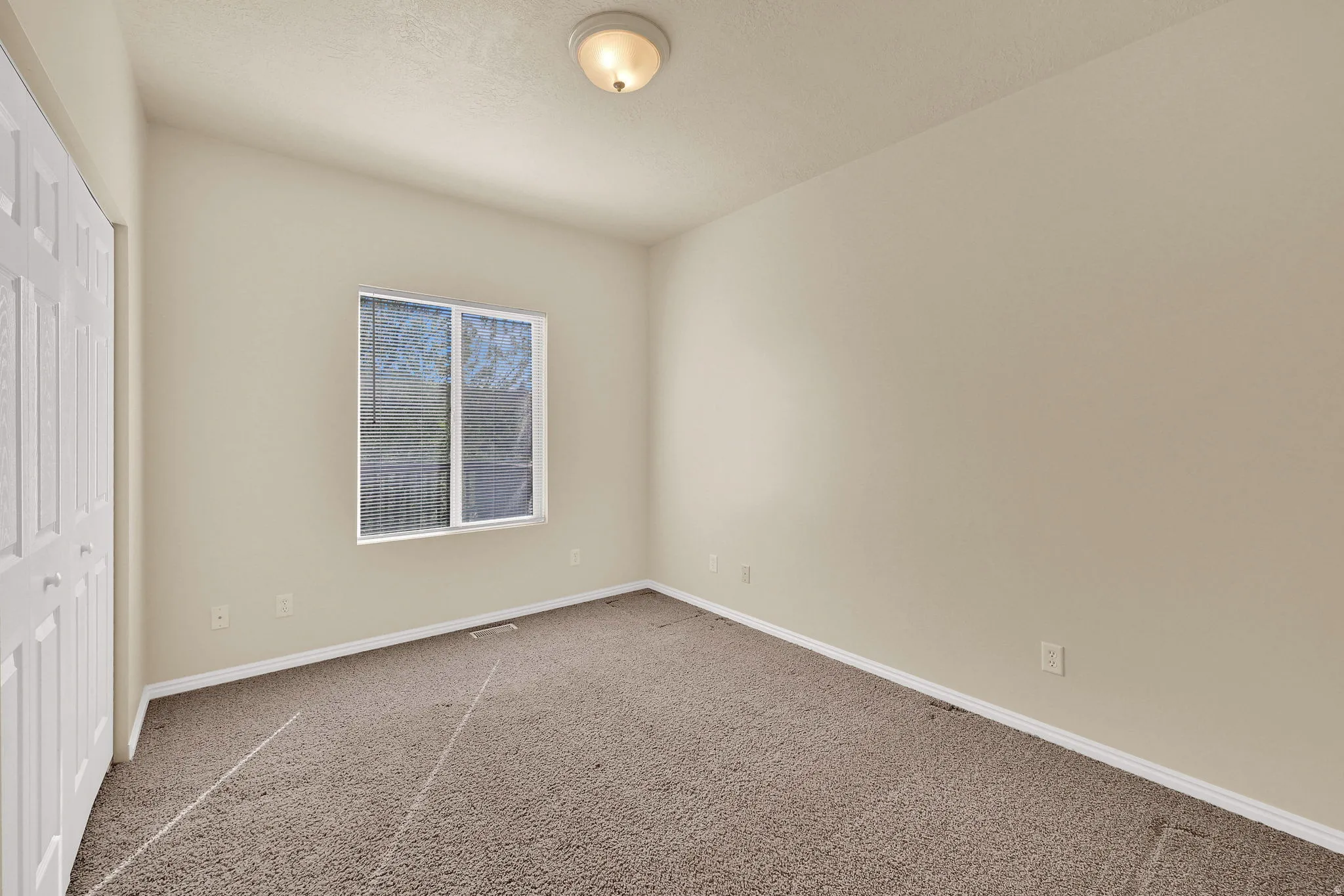 Unfurnished bedroom with a closet and carpet floors