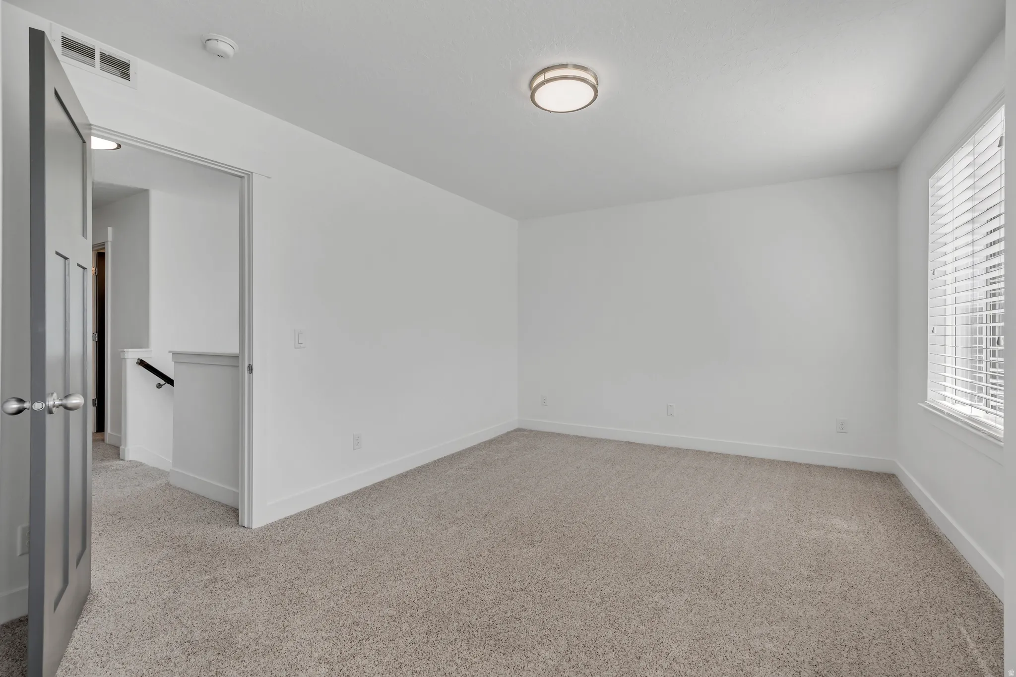 Spare room featuring light carpet