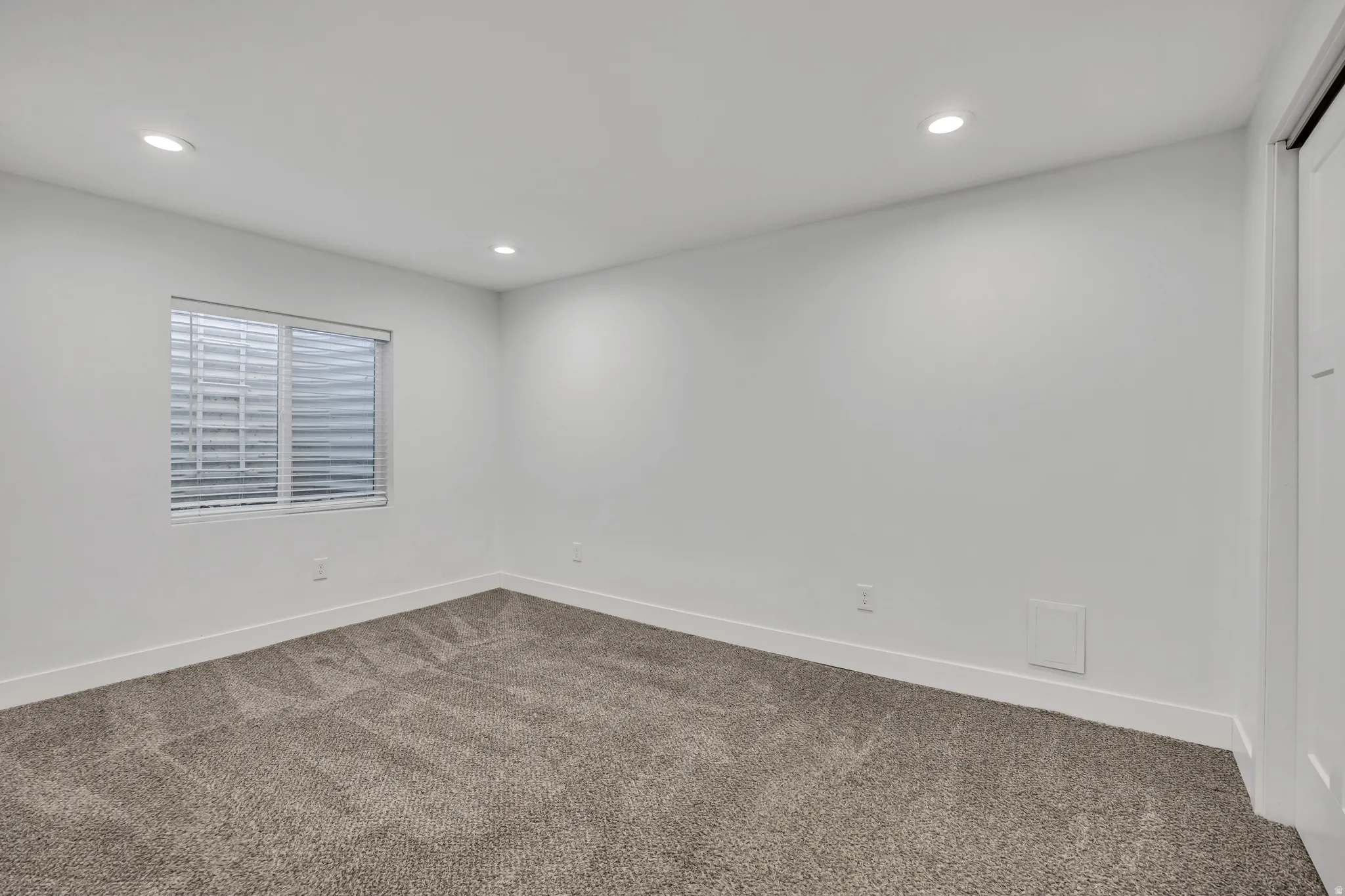 Unfurnished room with carpet floors and recessed lighting