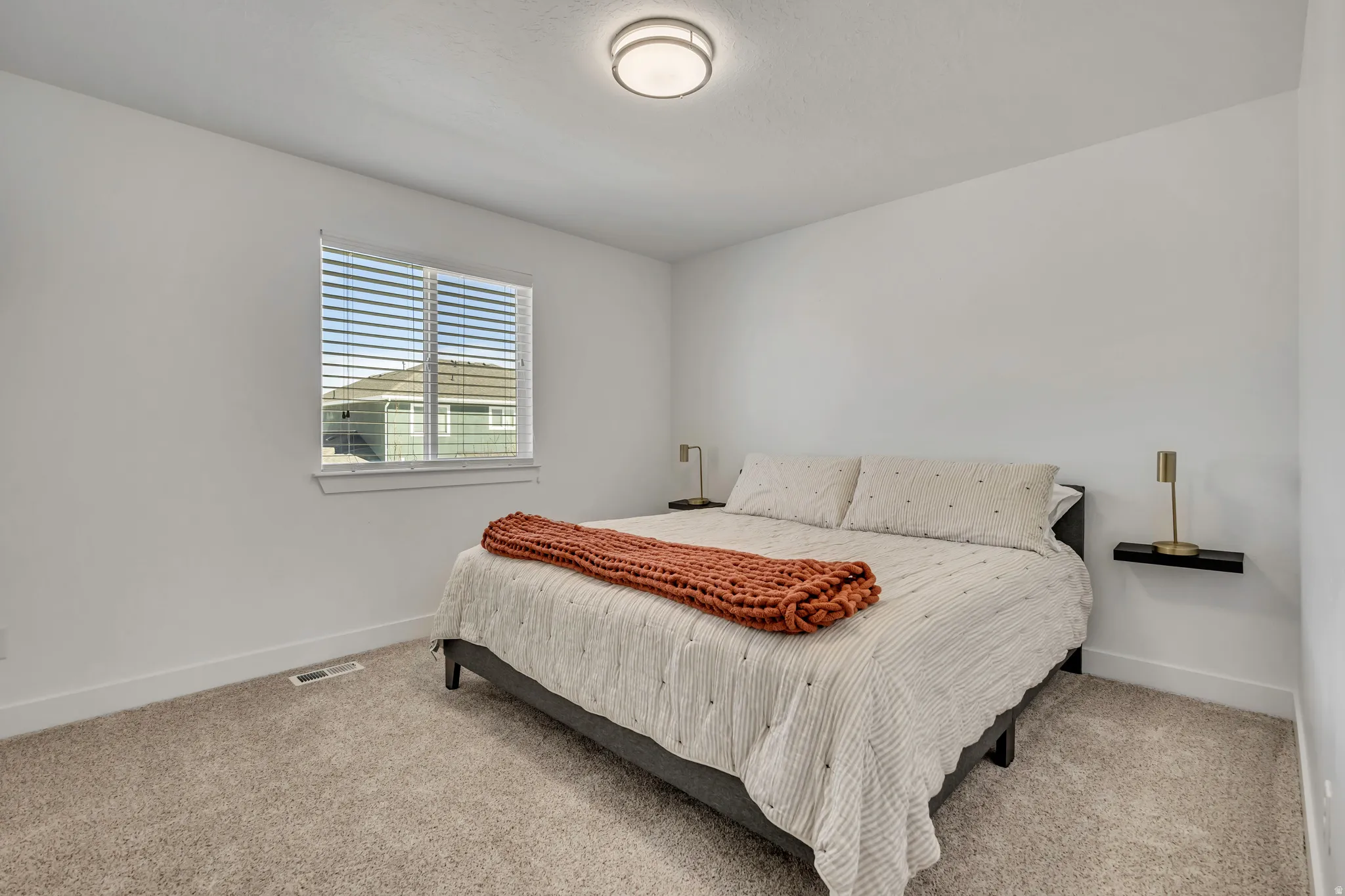 Carpeted bedroom with baseboards