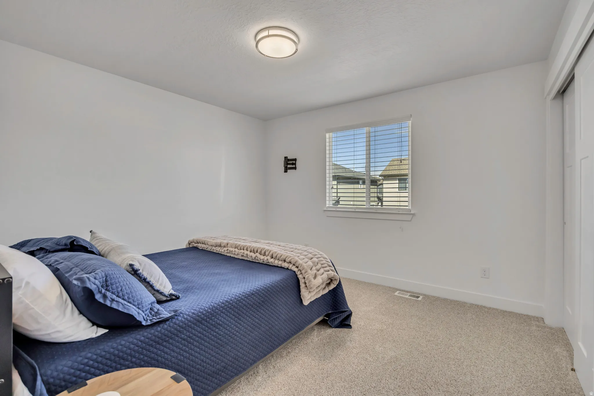 Carpeted bedroom featuring baseboards