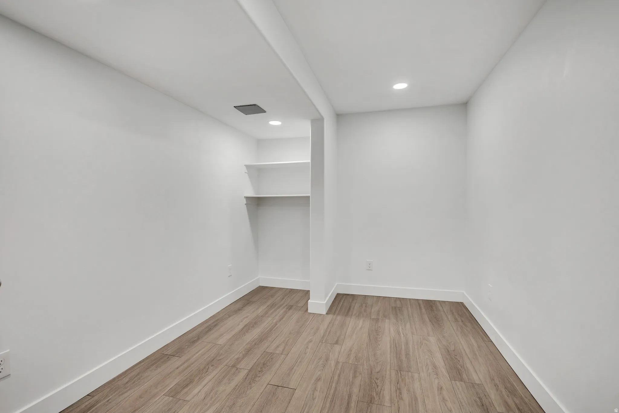 Spare room featuring light wood-style flooring and recessed lighting