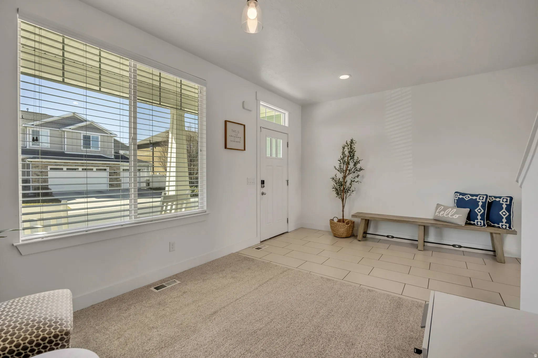 Entryway featuring light tile patterned flooring and recessed lighting
