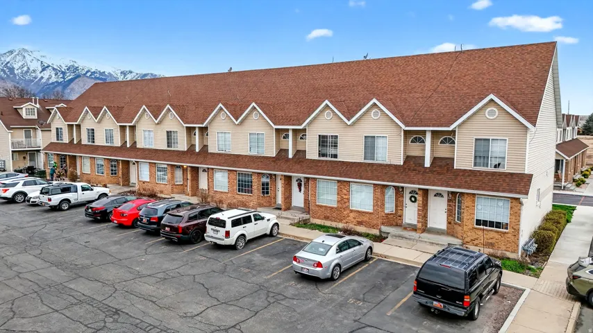 View of building exterior with uncovered parking and a mountain view