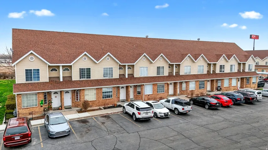 View of property featuring uncovered parking