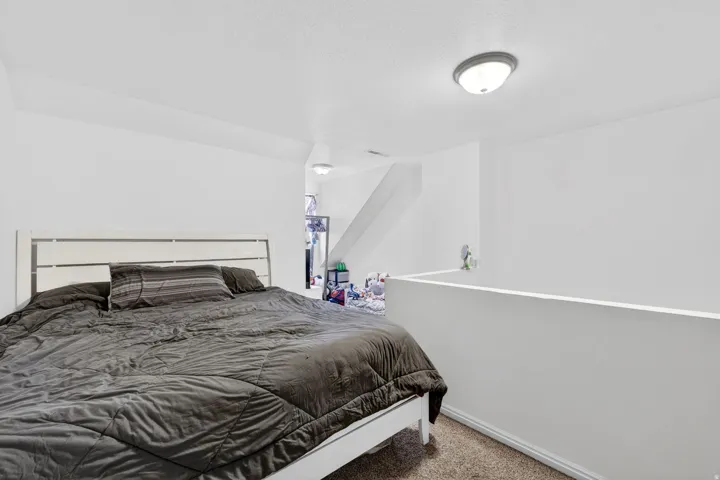 Carpeted bedroom featuring baseboards