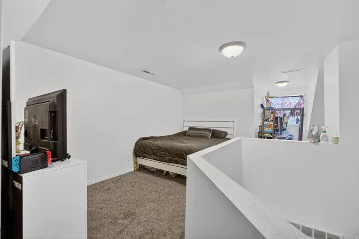Bedroom with dark carpet and baseboards
