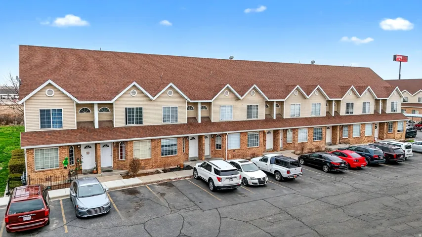 View of property with uncovered parking
