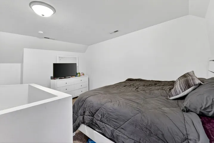 Bedroom with vaulted ceiling