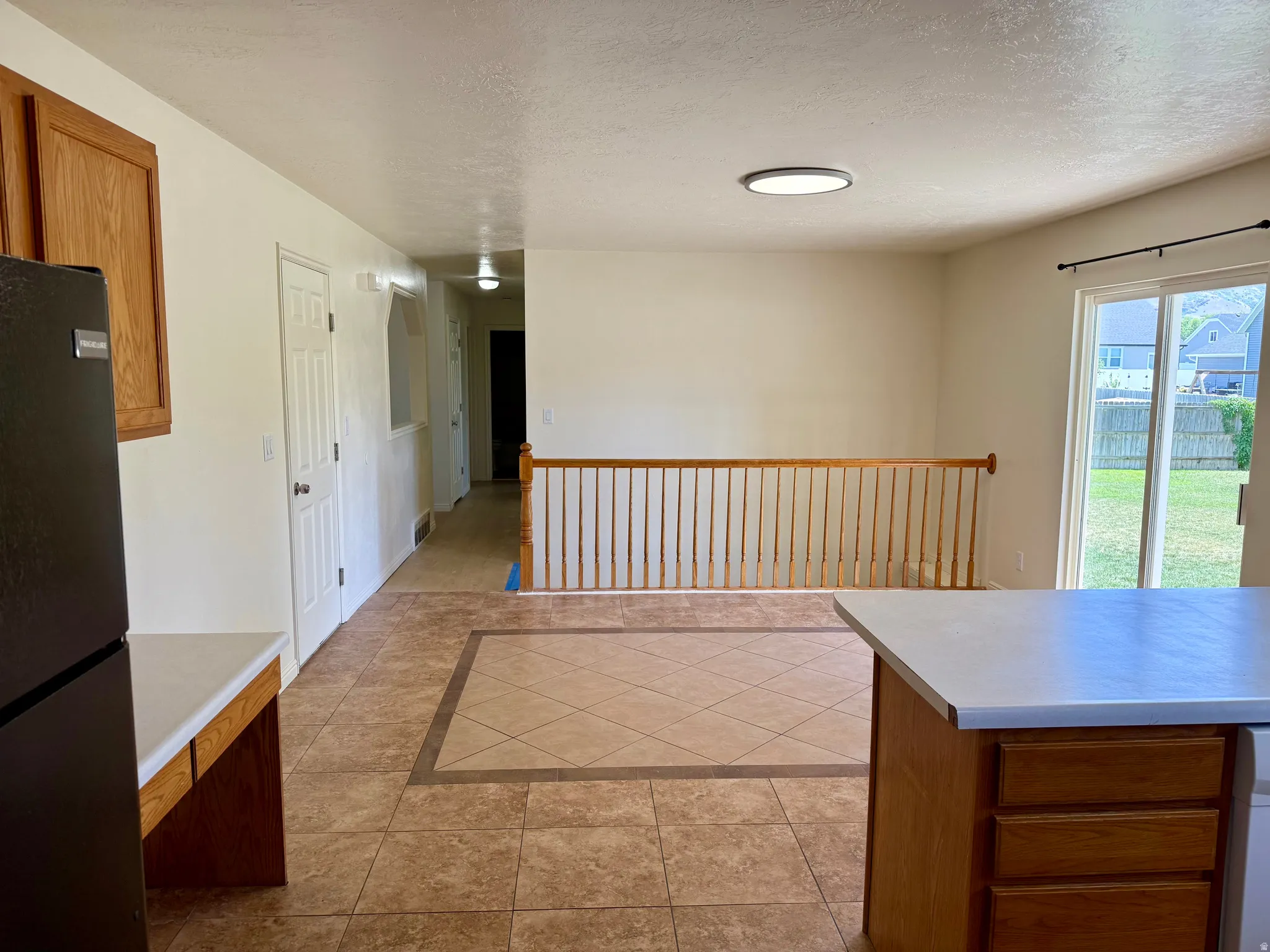 Expansive interior featuring durable tile flooring with a decorative inlay