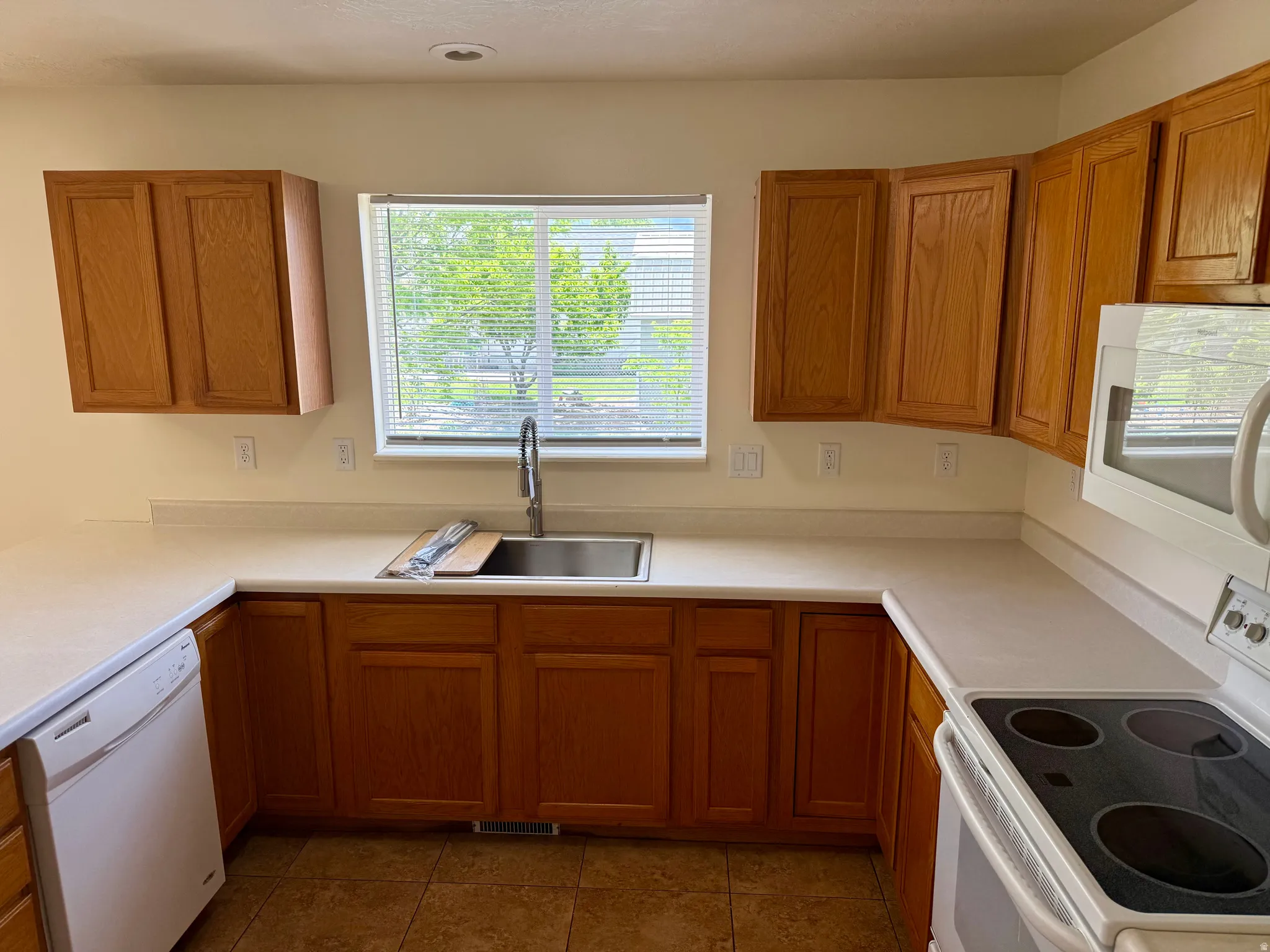 Kitchen featuring light wood cabinetry and light-toned countertops