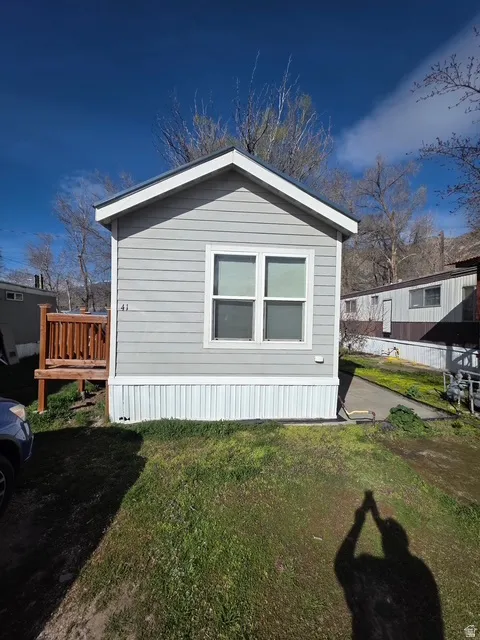 View of side of property with a lawn