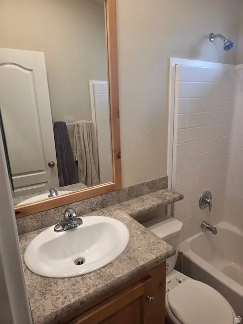 Bathroom featuring vanity and shower / tub combination