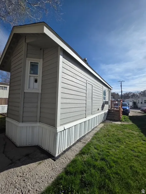 View of property exterior featuring a yard