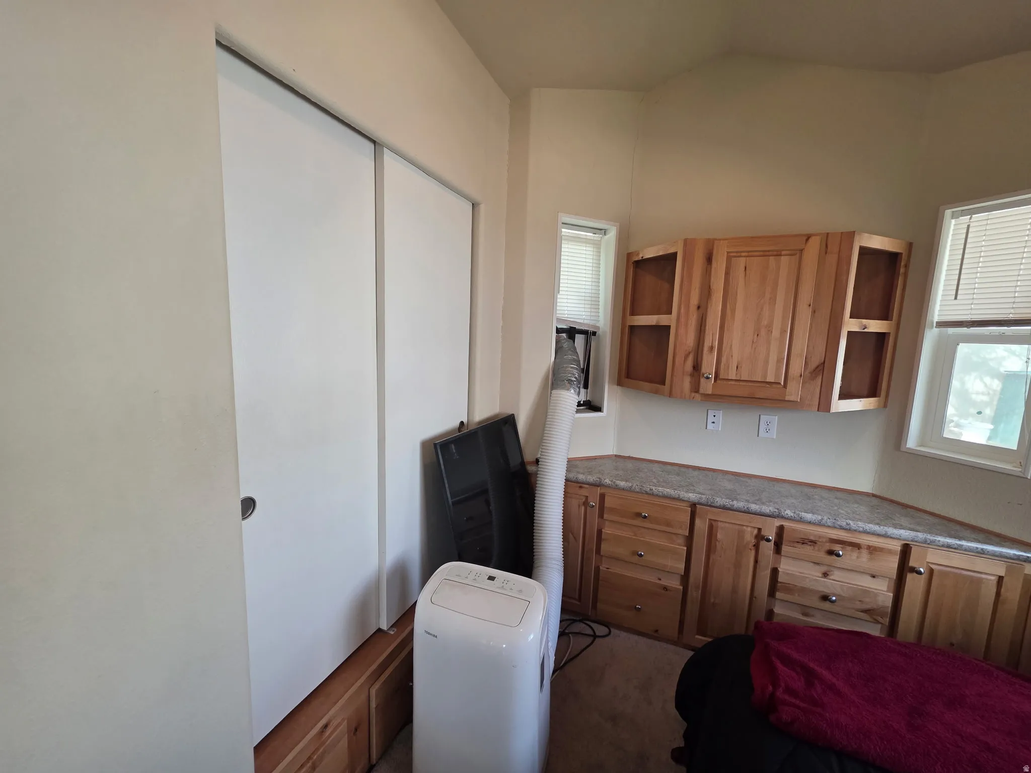 Kitchen featuring healthy amount of natural light and wood finish cabinets