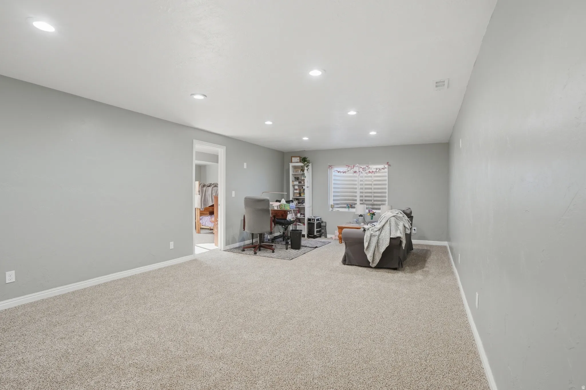 Interior space with a desk, carpet, and recessed lighting