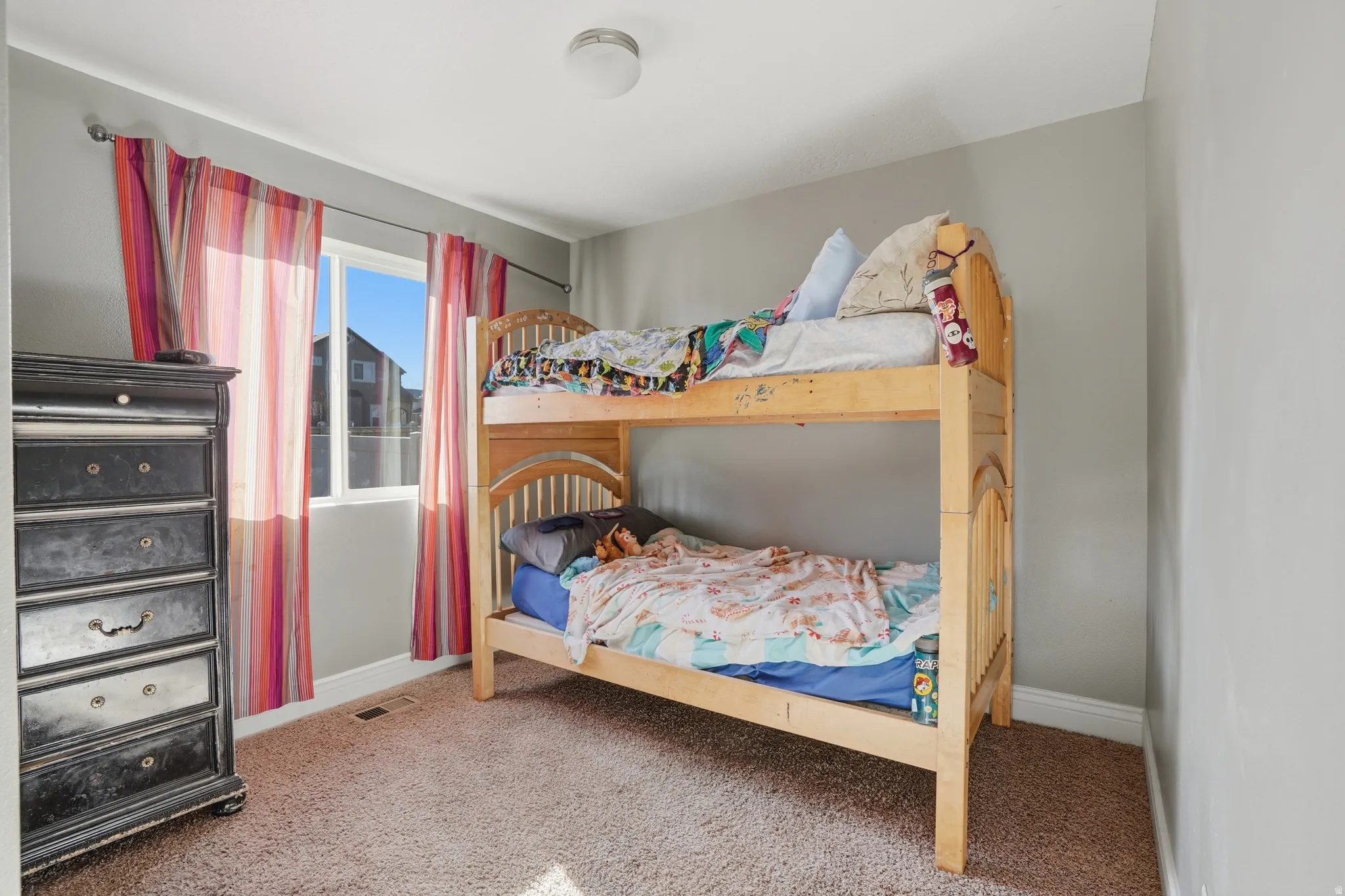 Bedroom with baseboards and light carpet